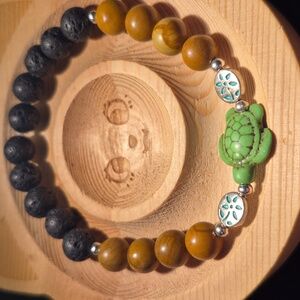 Petrified wood with green turtle and lava beads